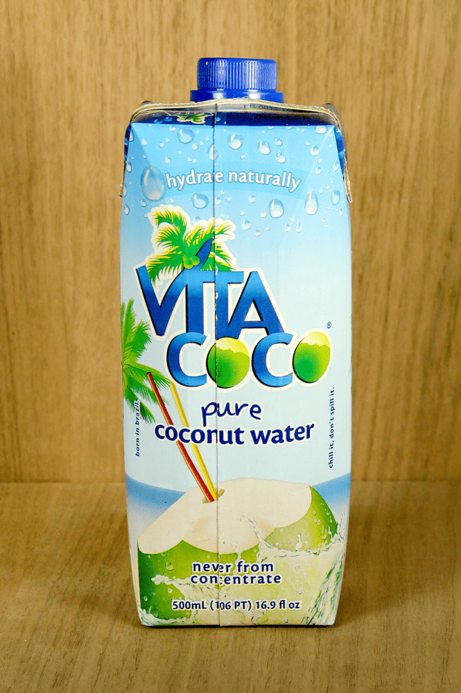 A person drinking coconut water for electrolyte replenishment